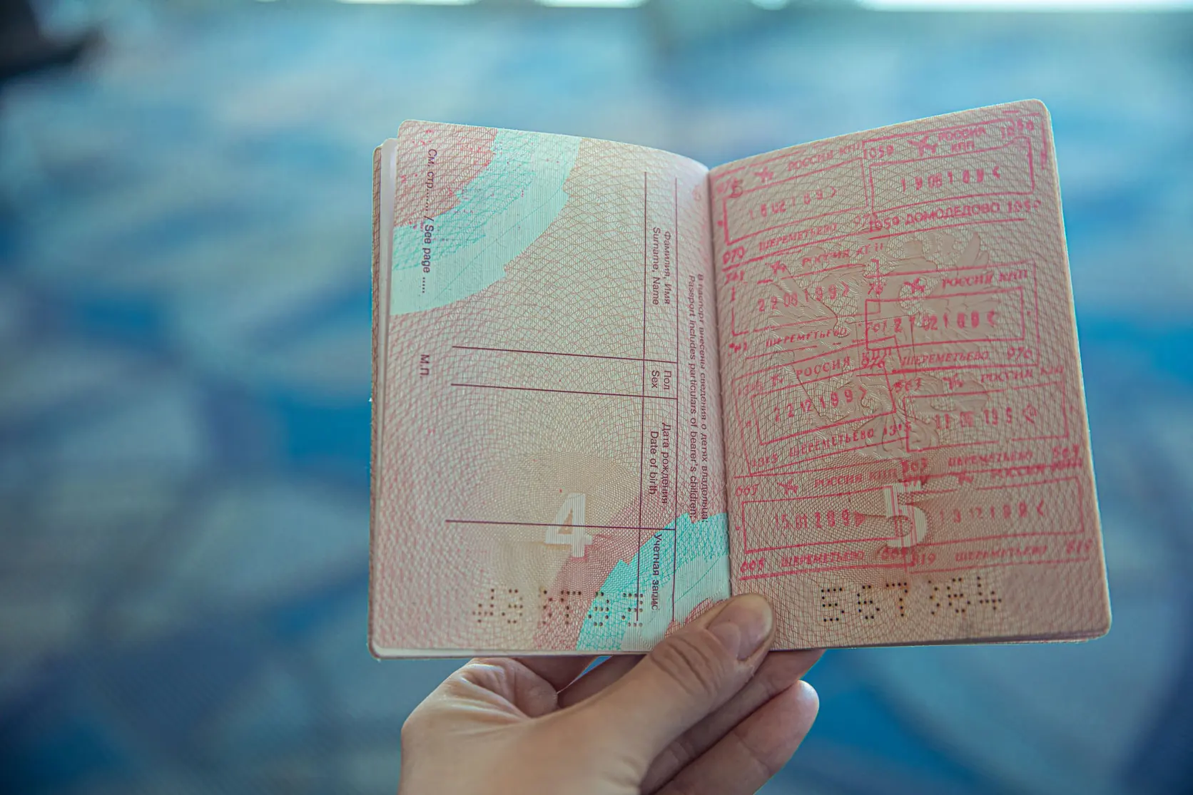 An open passport page with entry stamps